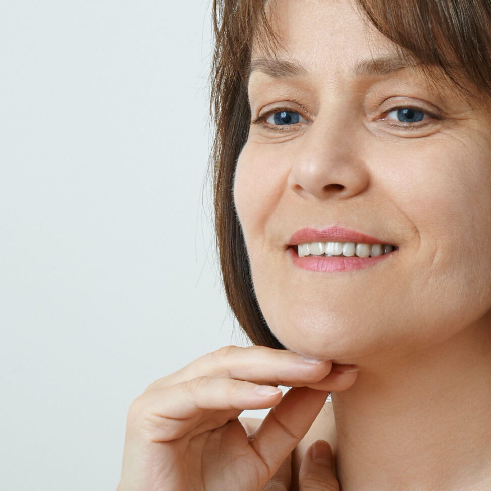 women touching her face and looking down