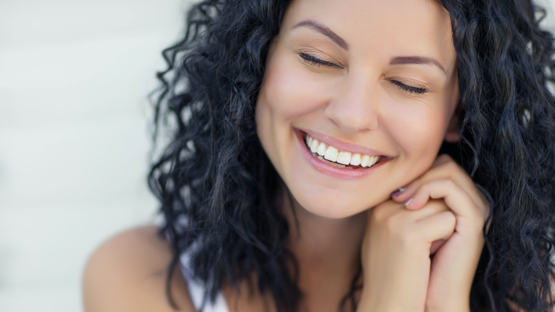 curly haired woman smiling