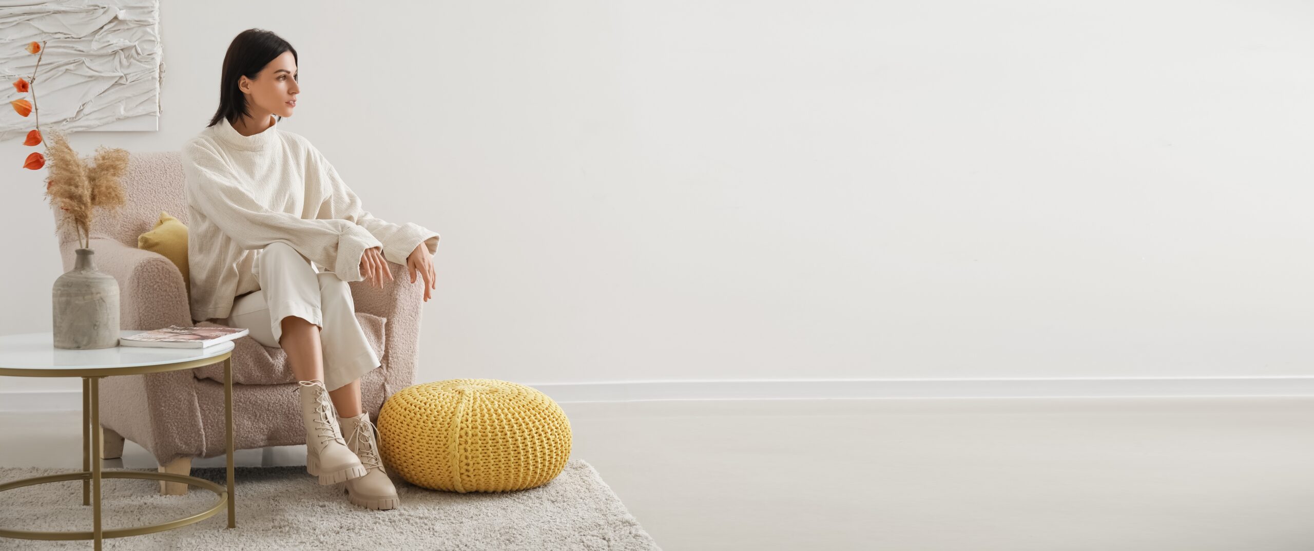 women sitting in a chair with a cream background